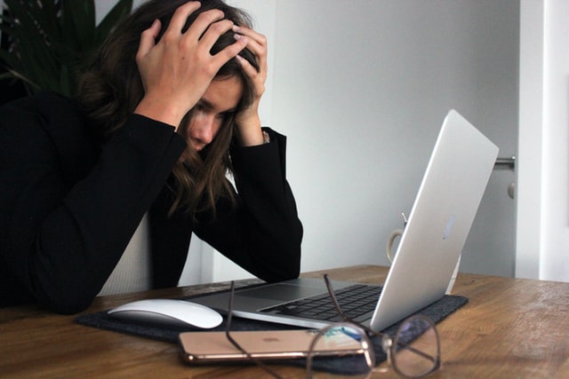 stressed out woman looking at laptop